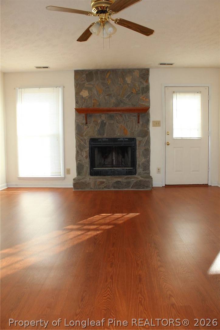 7805 Gallant Ridge Drive Fayetteville, NC 28314 - Photo 5 of 25 a view of empty room with wooden floor and fireplace