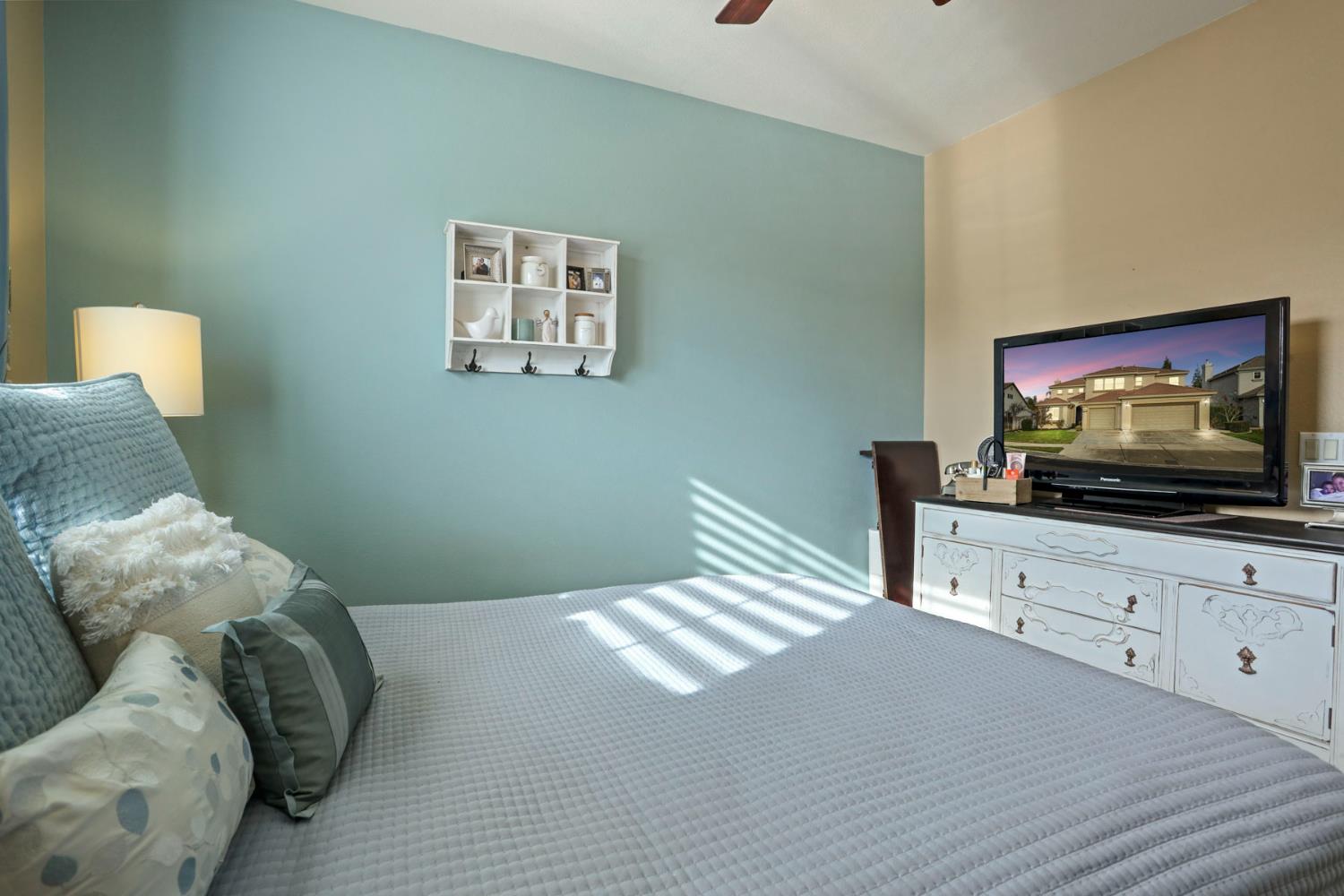 565 Bodeson Court Ripon, CA 95366 - Photo 14 of 65 a bedroom with a bed and a flat screen tv