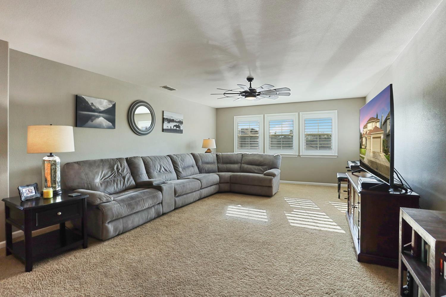 565 Bodeson Court Ripon, CA 95366 - Photo 33 of 65 a living room with furniture and a flat screen tv