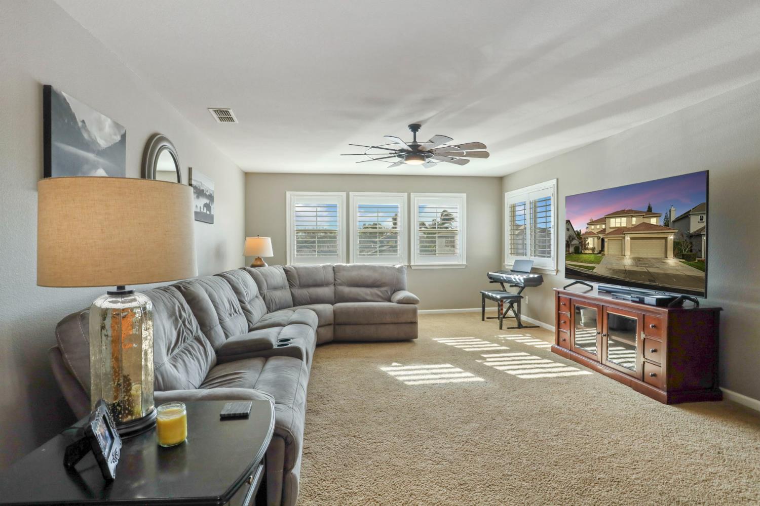 565 Bodeson Court Ripon, CA 95366 - Photo 34 of 65 a living room with furniture and a flat screen tv
