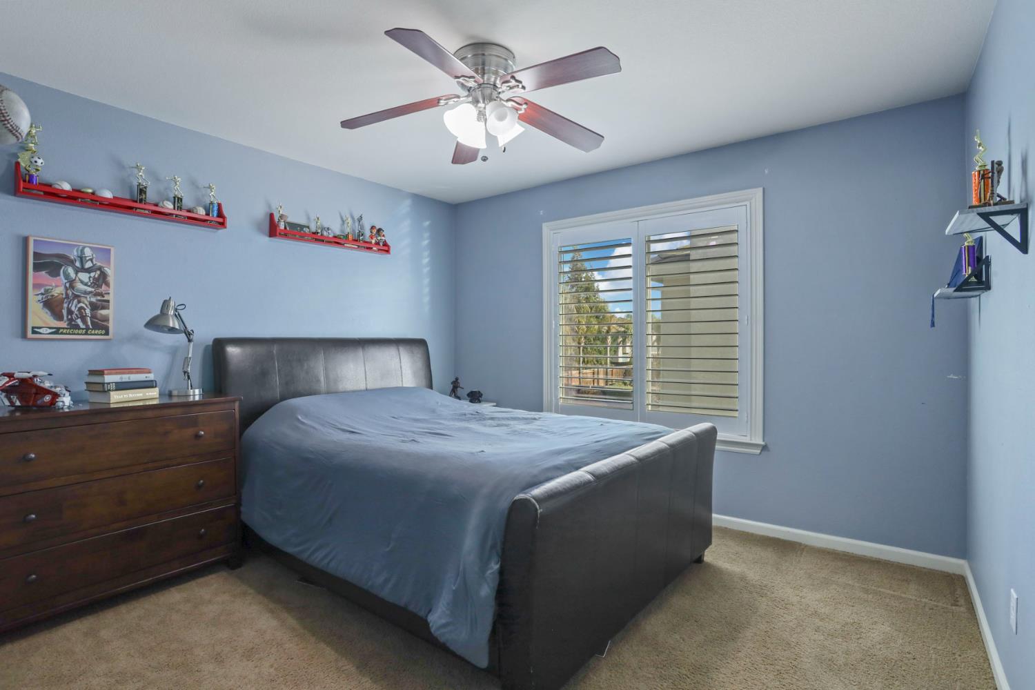 565 Bodeson Court Ripon, CA 95366 - Photo 37 of 65 a bedroom with a bed and a chandelier