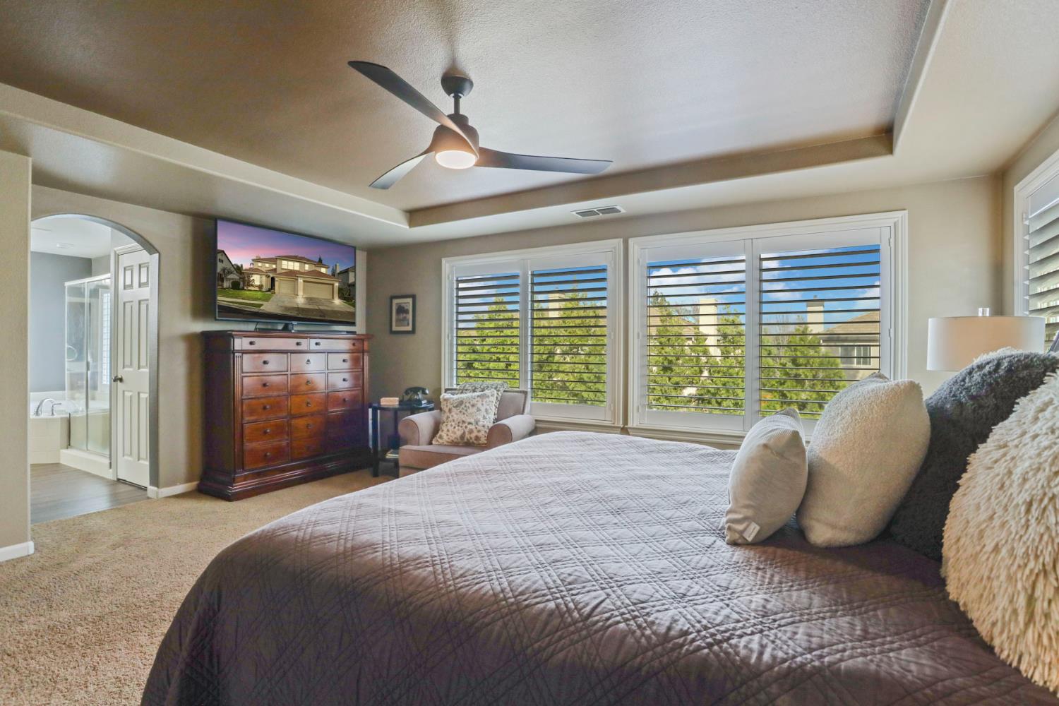 565 Bodeson Court Ripon, CA 95366 - Photo 40 of 65 a spacious bedroom with a large bed and a flat tv screen