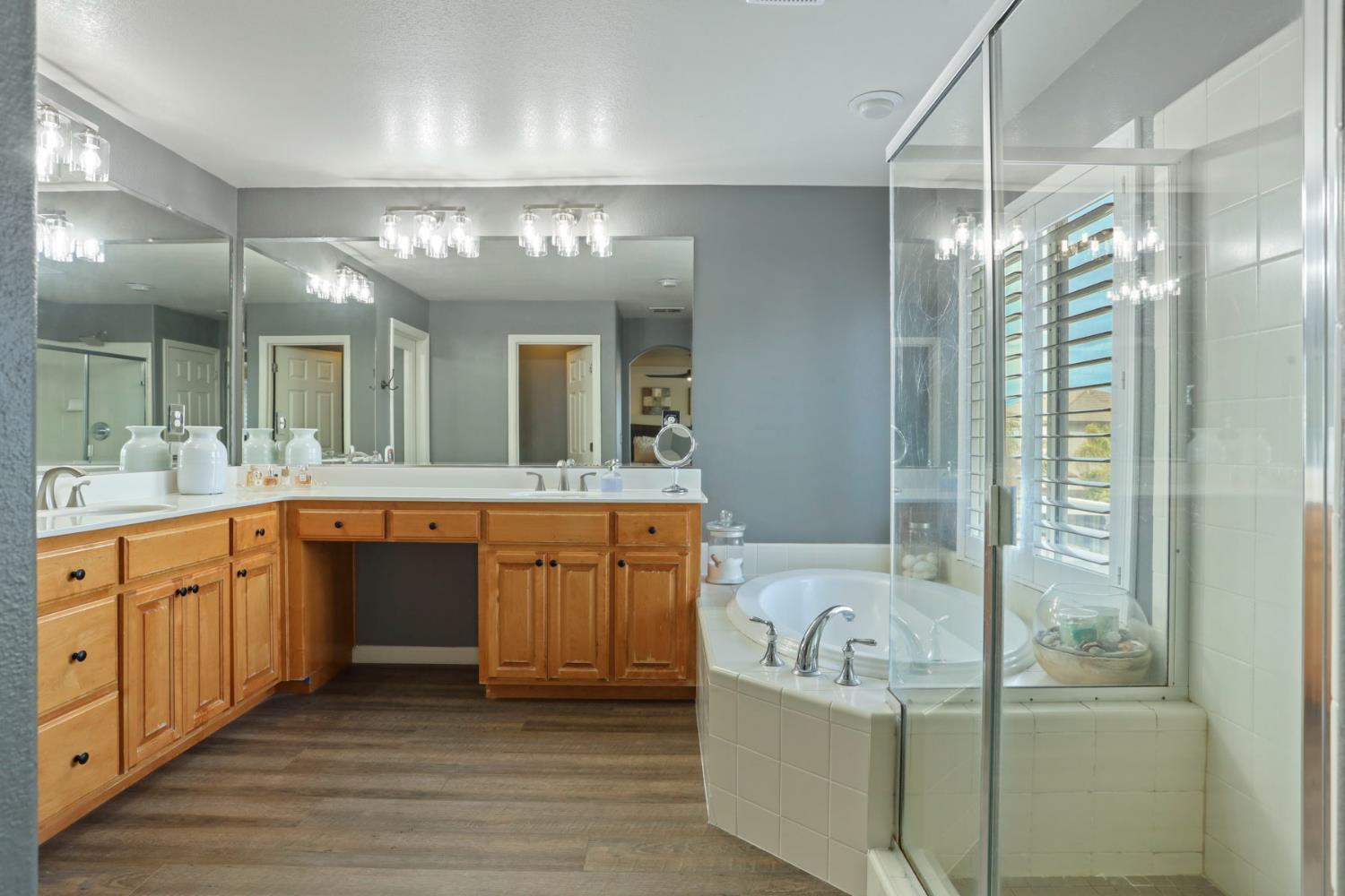 565 Bodeson Court Ripon, CA 95366 - Photo 41 of 65 a bathroom with a granite countertop tub sink shower double vanity