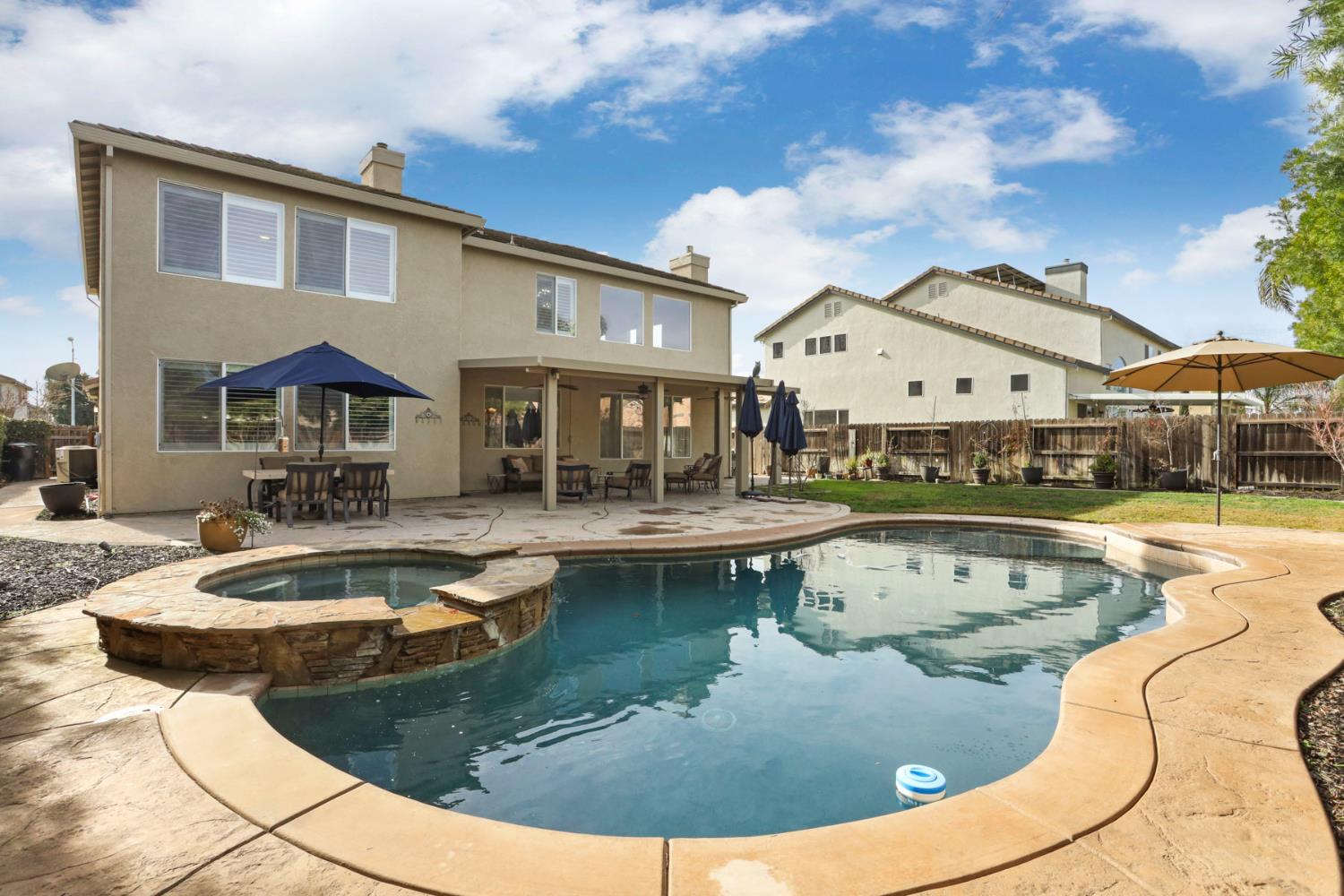 565 Bodeson Court Ripon, CA 95366 - Photo 55 of 65 a view of a house with swimming pool and sitting area