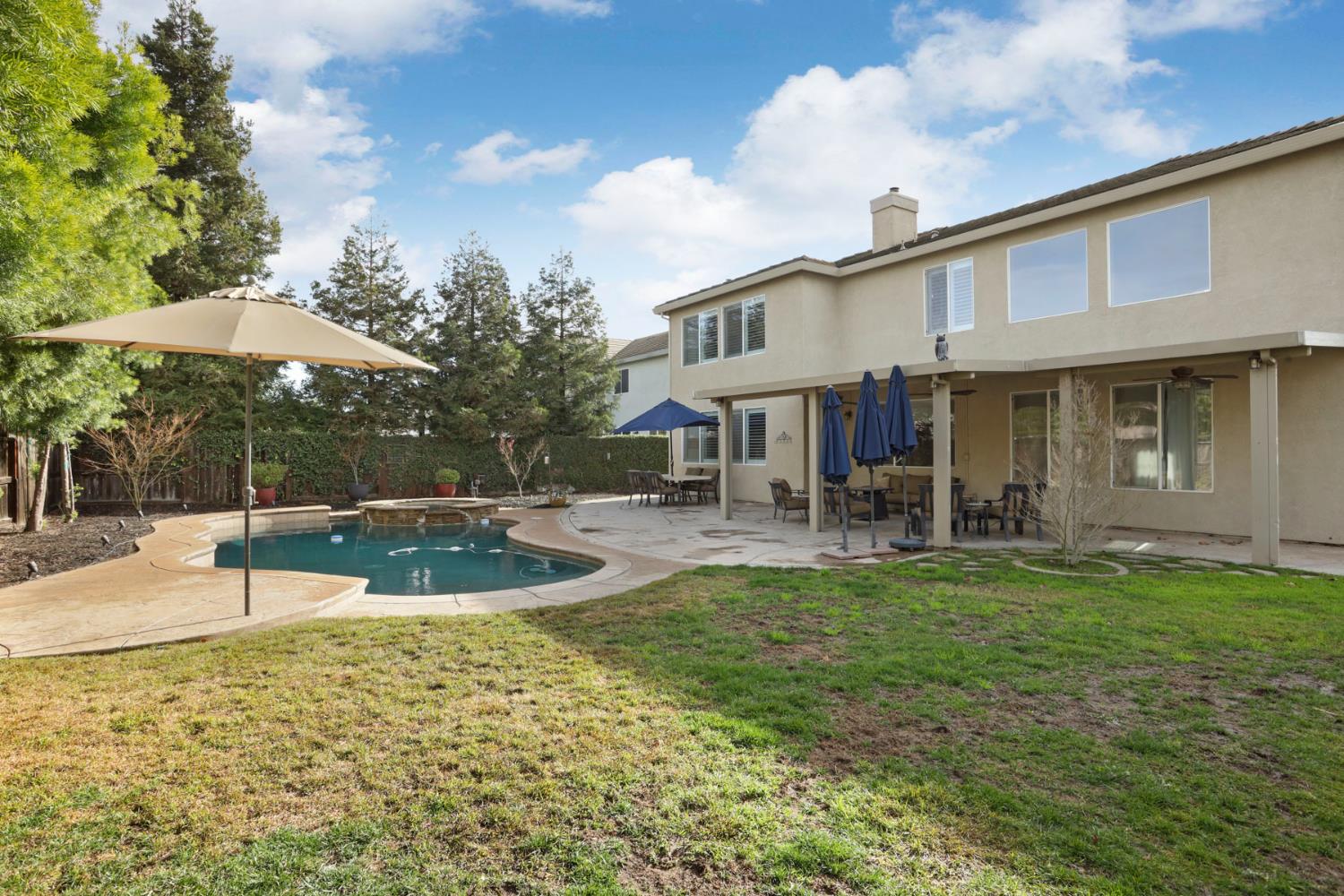 565 Bodeson Court Ripon, CA 95366 - Photo 62 of 65 a view of a house with swimming pool and a yard