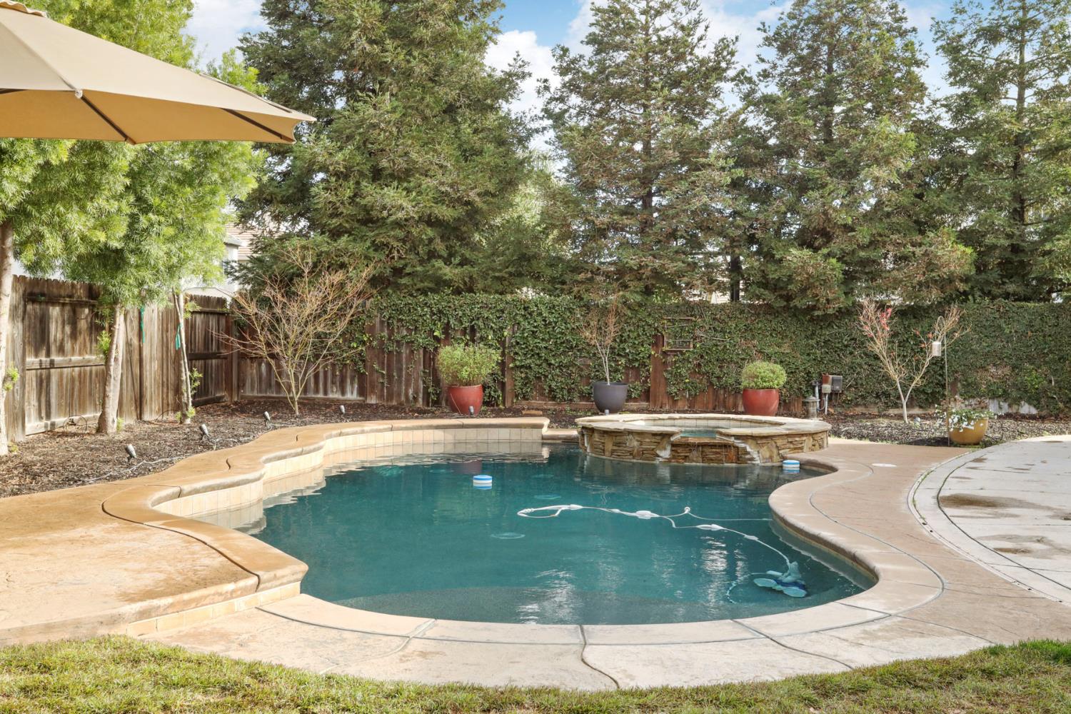 565 Bodeson Court Ripon, CA 95366 - Photo 63 of 65 a view of a swimming pool with a sitting area