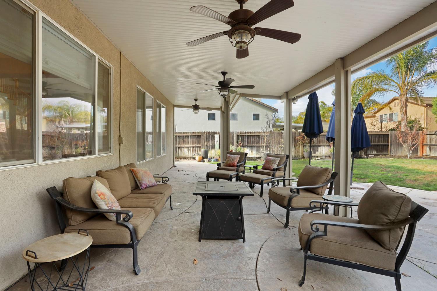 565 Bodeson Court Ripon, CA 95366 - Photo 64 of 65 a living room with patio furniture and a large window