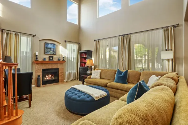 a living room with furniture and a floor to ceiling window