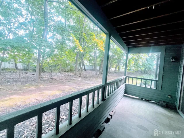 a view of porch with green trees