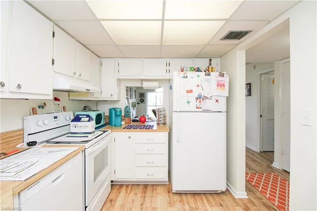 a kitchen with a refrigerator and cabinets