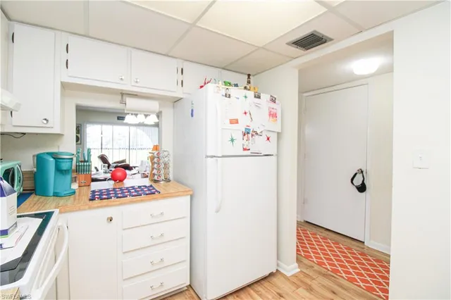 a living room with furniture a wooden floor and a chandelier