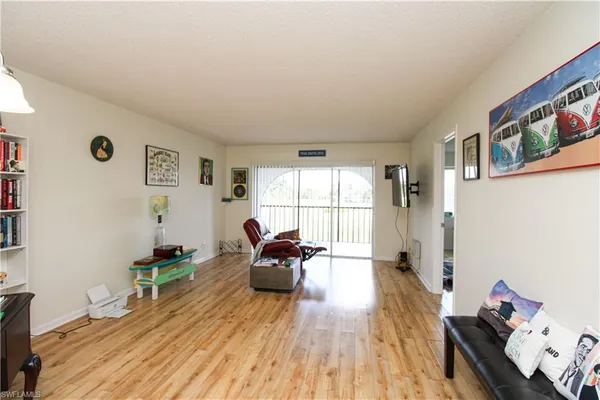 a room with furniture wooden floor and window