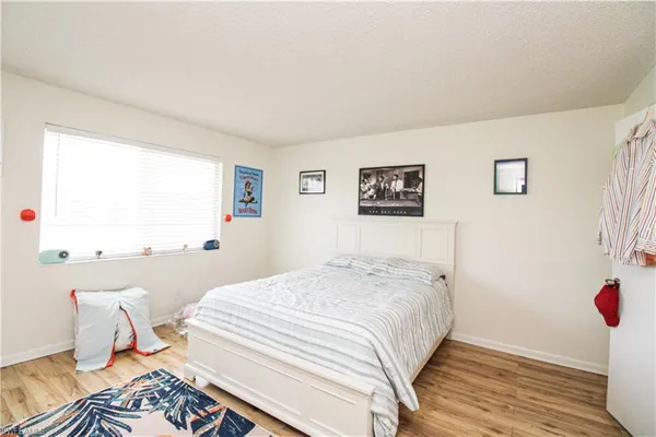 a bedroom with bed and wall painting