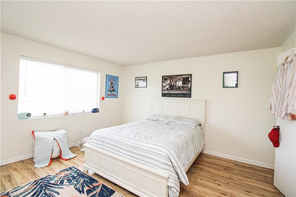 41 High Point Circle South, Unit 303 Naples, FL 34103 - Photo 20 of 39 a bedroom with a bed and a window