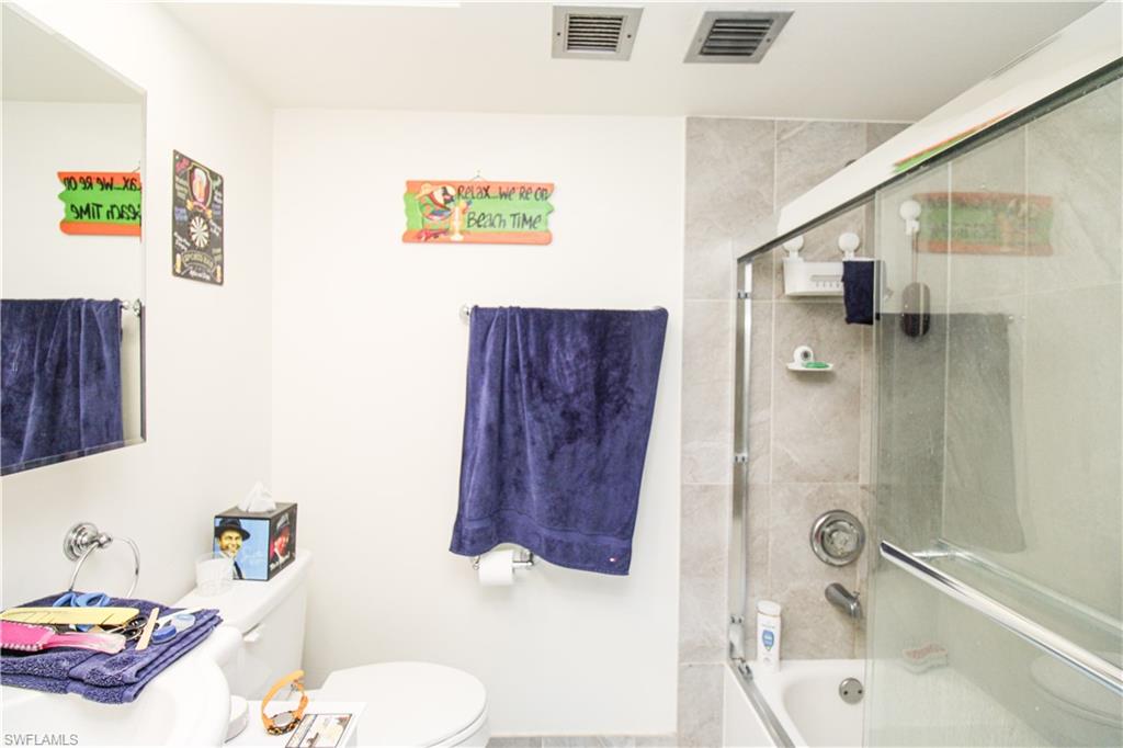 41 High Point Circle South, Unit 303 Naples, FL 34103 - Photo 23 of 39 a bathroom with a sink toilet and shower