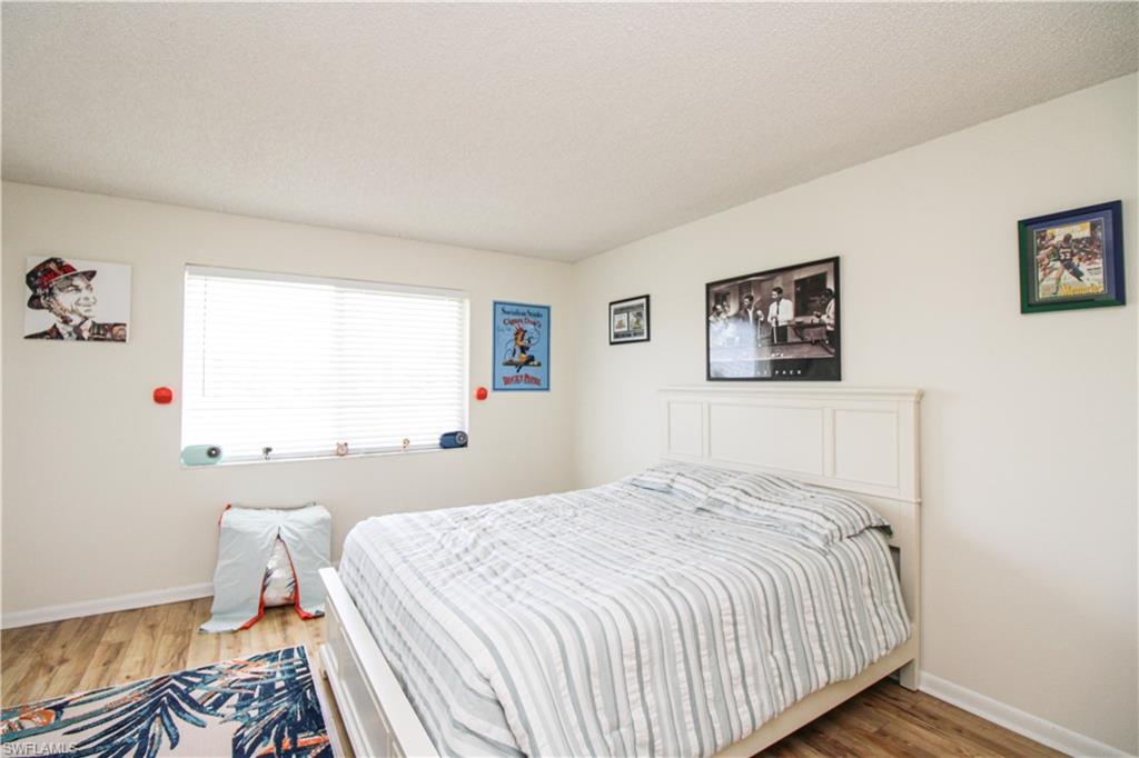 41 High Point Circle South, Unit 303 Naples, FL 34103 - Photo 24 of 39 a bedroom with a bed and a window