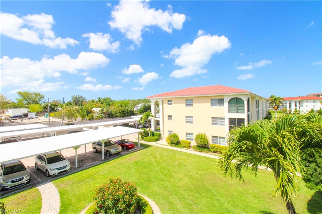 41 High Point Circle South, Unit 303 Naples, FL 34103 - Photo 28 of 39 a view of an swimming pool with seating area