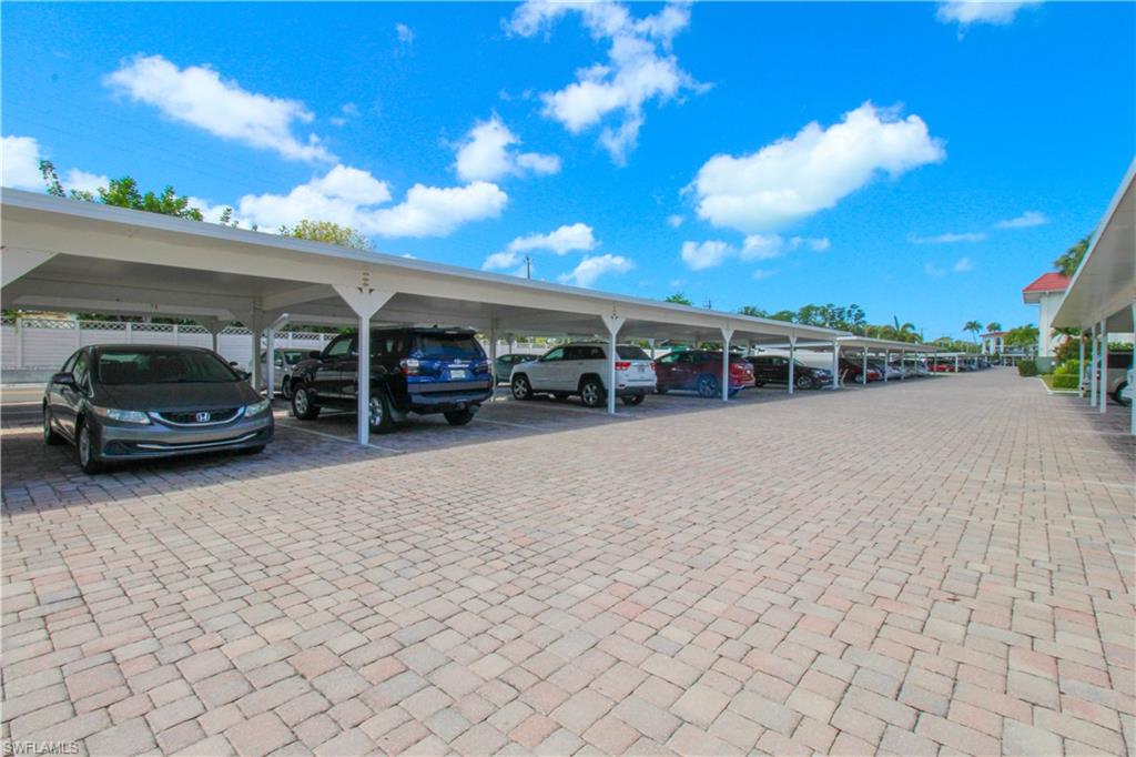 41 High Point Circle South, Unit 303 Naples, FL 34103 - Photo 33 of 39 a view of a car parked in front of a building