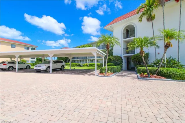 a front view of a multi story residential apartment building with a yard