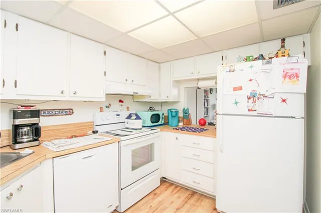 a kitchen with refrigerator and cabinets