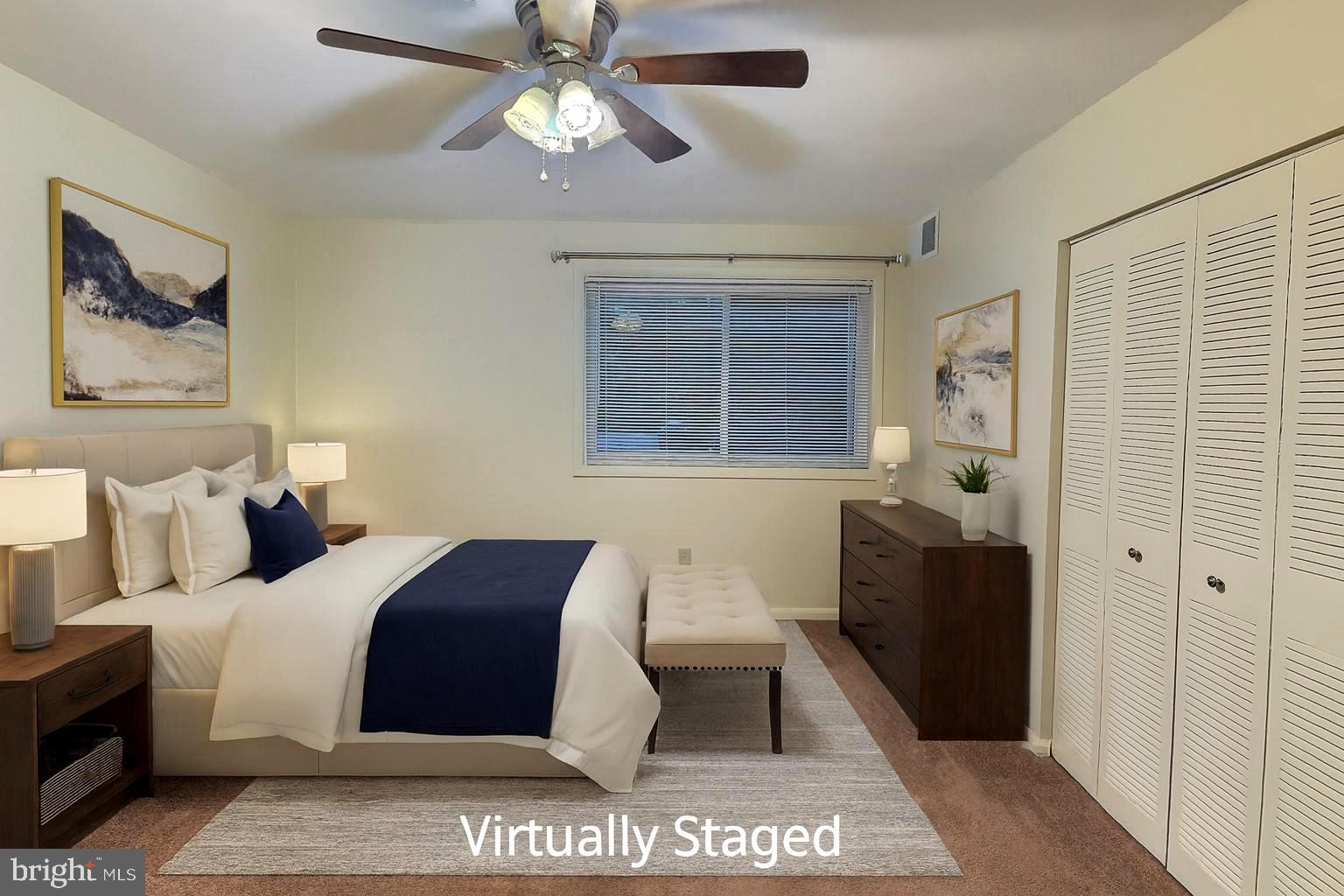 3136 Brinkley Road, Unit 204 Temple Hills, MD 20748 - Photo 3 of 19 a bedroom with a bed and a chandelier