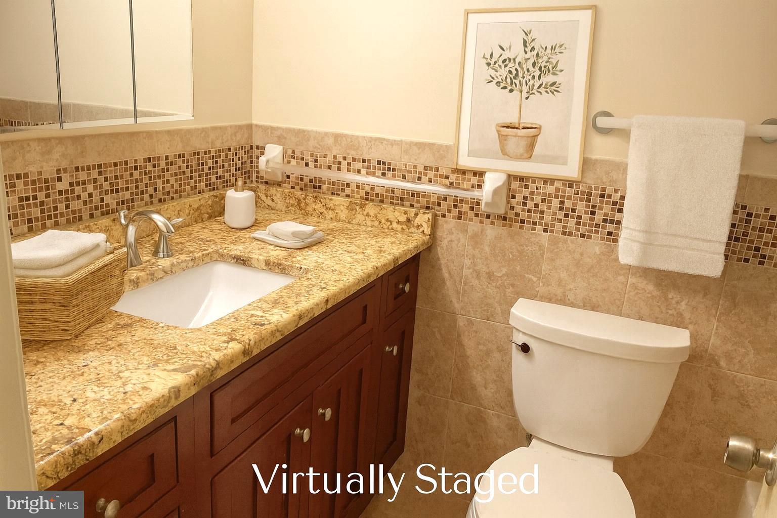 3136 Brinkley Road, Unit 204 Temple Hills, MD 20748 - Photo 5 of 19 a bathroom with a granite countertop toilet sink and mirror