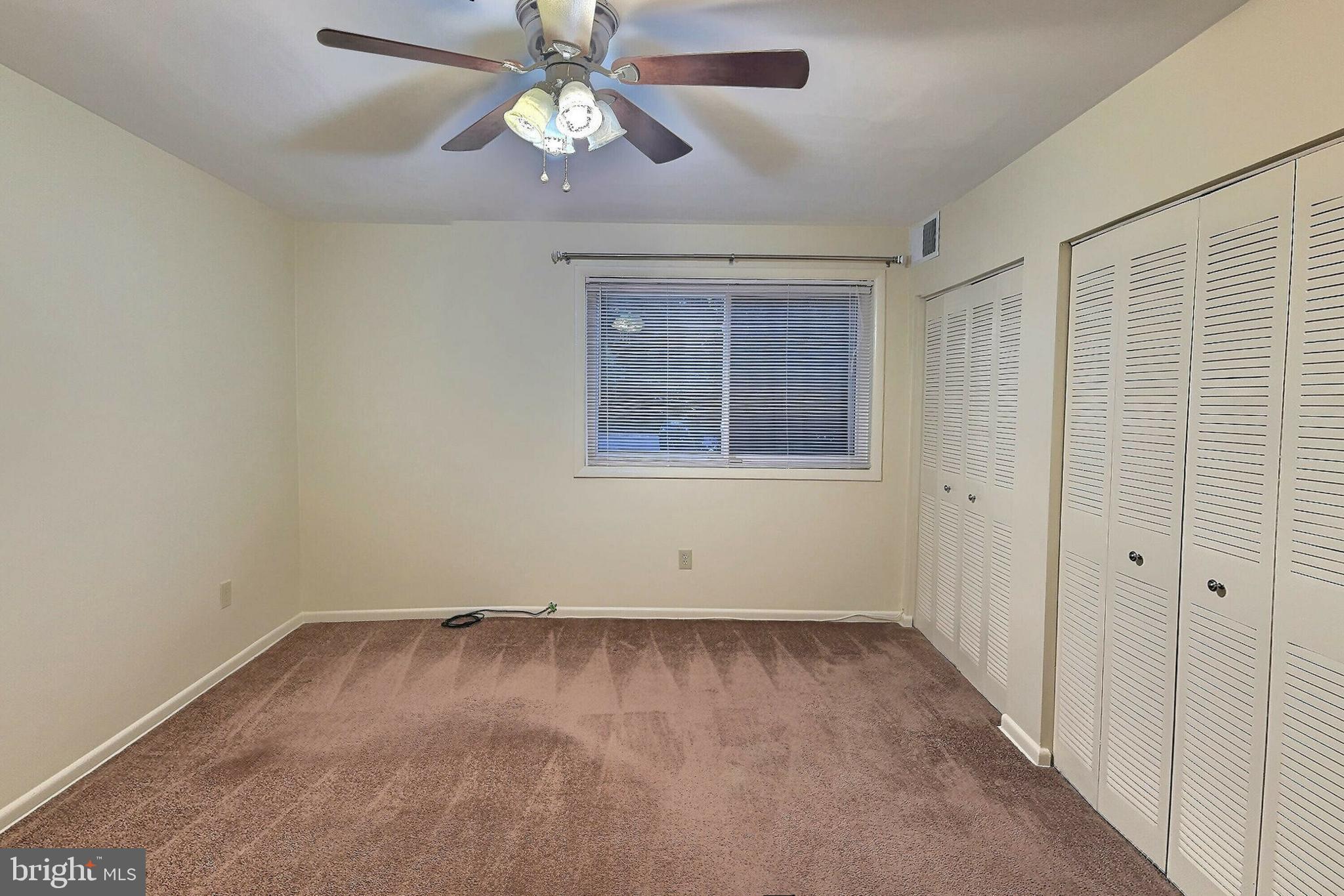 3136 Brinkley Road, Unit 204 Temple Hills, MD 20748 - Photo 9 of 19 a view of an empty room with a window