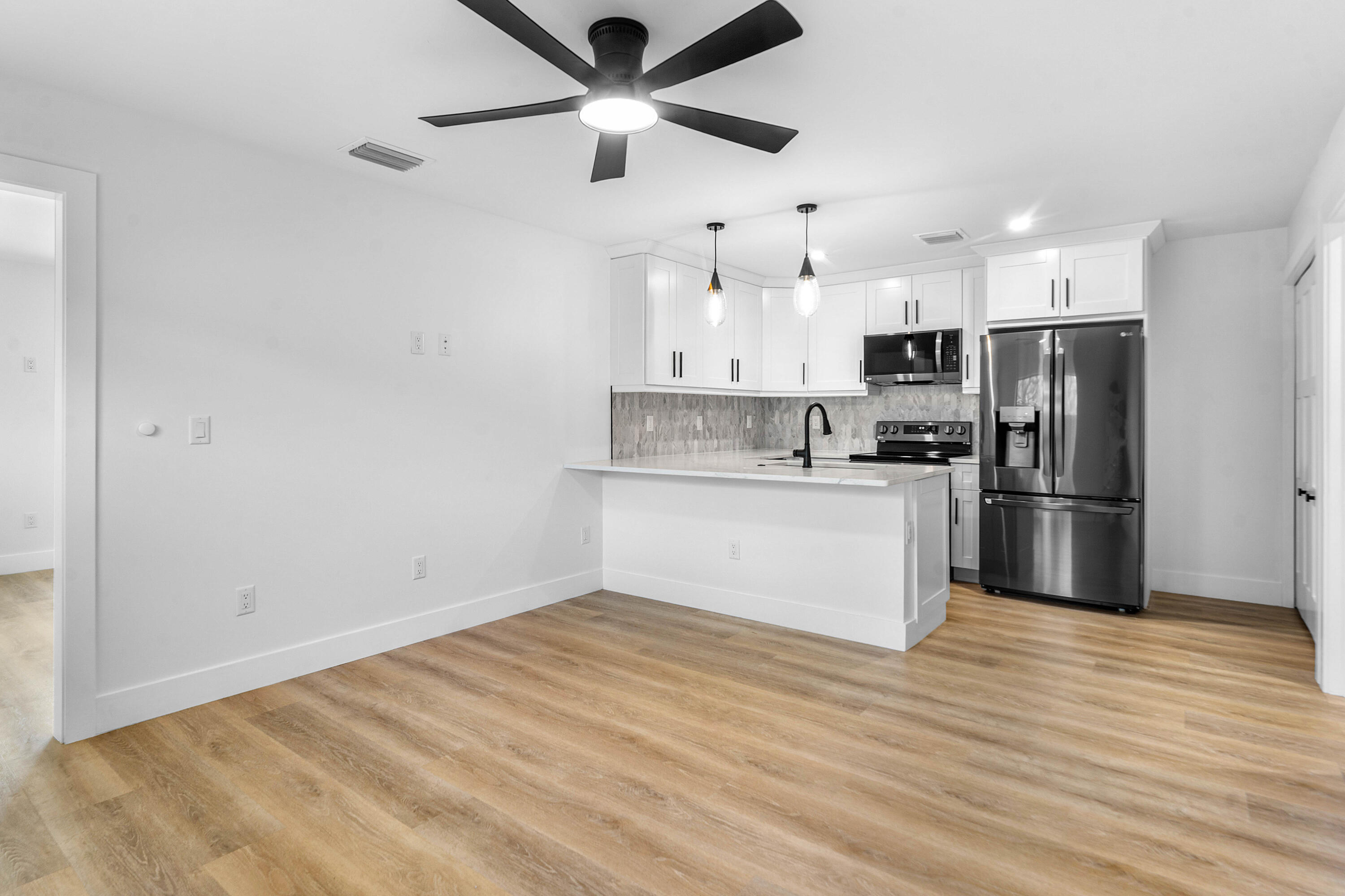 5701 Old Orange Road Jupiter, FL 33458 - Photo 34 of 46 a kitchen with stainless steel appliances a refrigerator and a stove top oven
