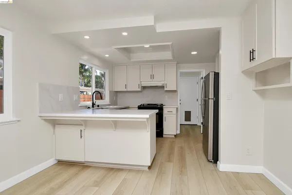 a kitchen with kitchen island granite countertop a stove and a sink