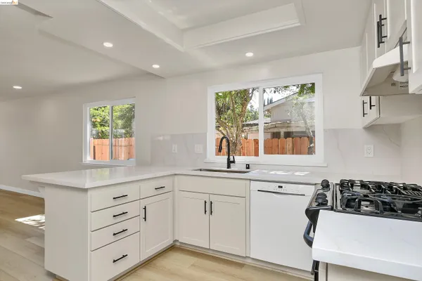 a kitchen with a refrigerator sink and cabinets