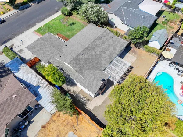 an aerial view of a house with a yard