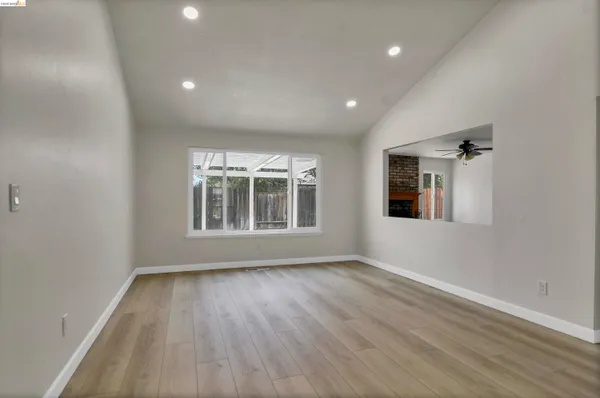 a view of a room with wooden floor and white walls
