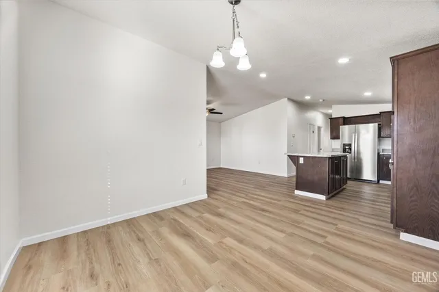 a view of a kitchen with a sink and wooden floor