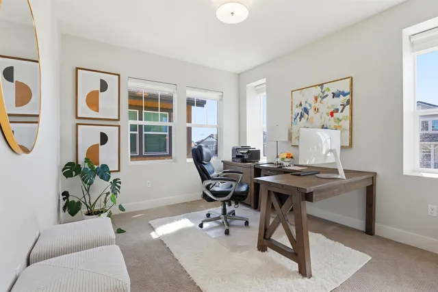 a view of a workspace with a window and bathroom