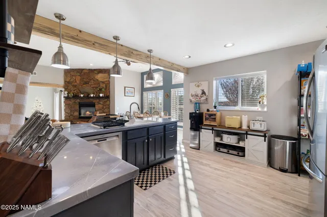 a living room with furniture a table and a large window