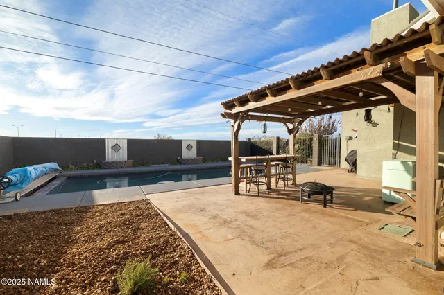 a view of a house with pool and chairs