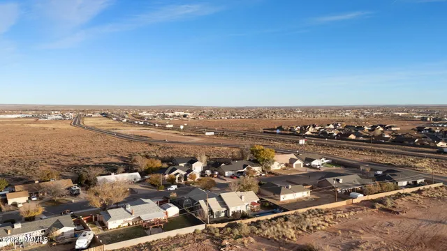 a spacious bedroom with a bed and a chandelier