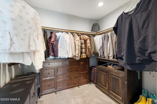 a spacious bedroom with a bed and a chandelier