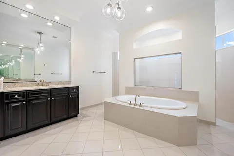 a bathroom with a granite countertop sink a toilet and bathtub