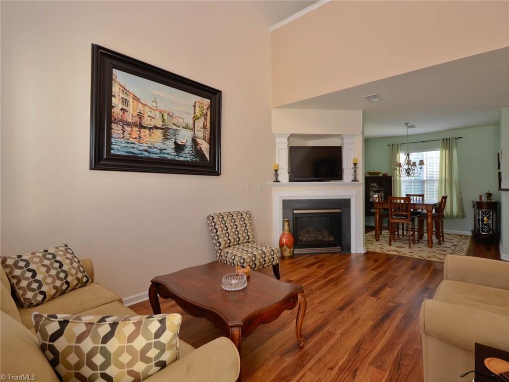 815 Hartley Hill Court High Point, NC 27265 - Photo 3 of 23 Living room with gleaming hardwoods and gas log fireplace.