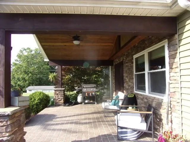 a view of a porch with furniture and yard