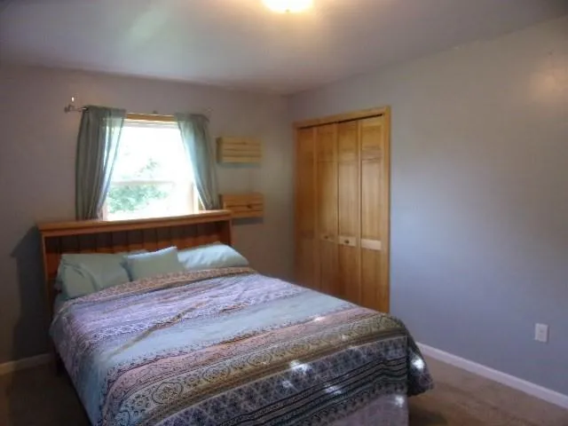 a bedroom with a bed and window