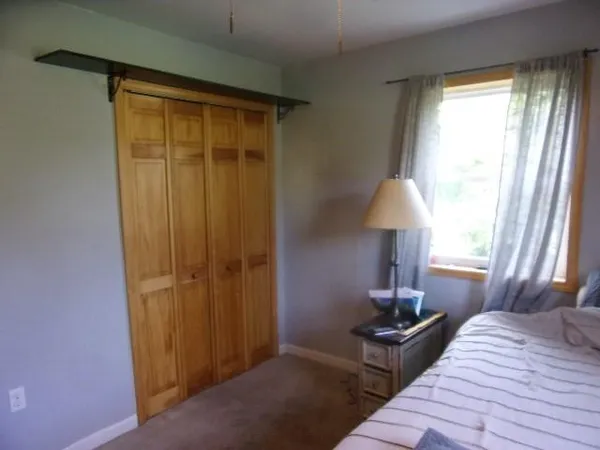 a bed room with a bed and a lamp