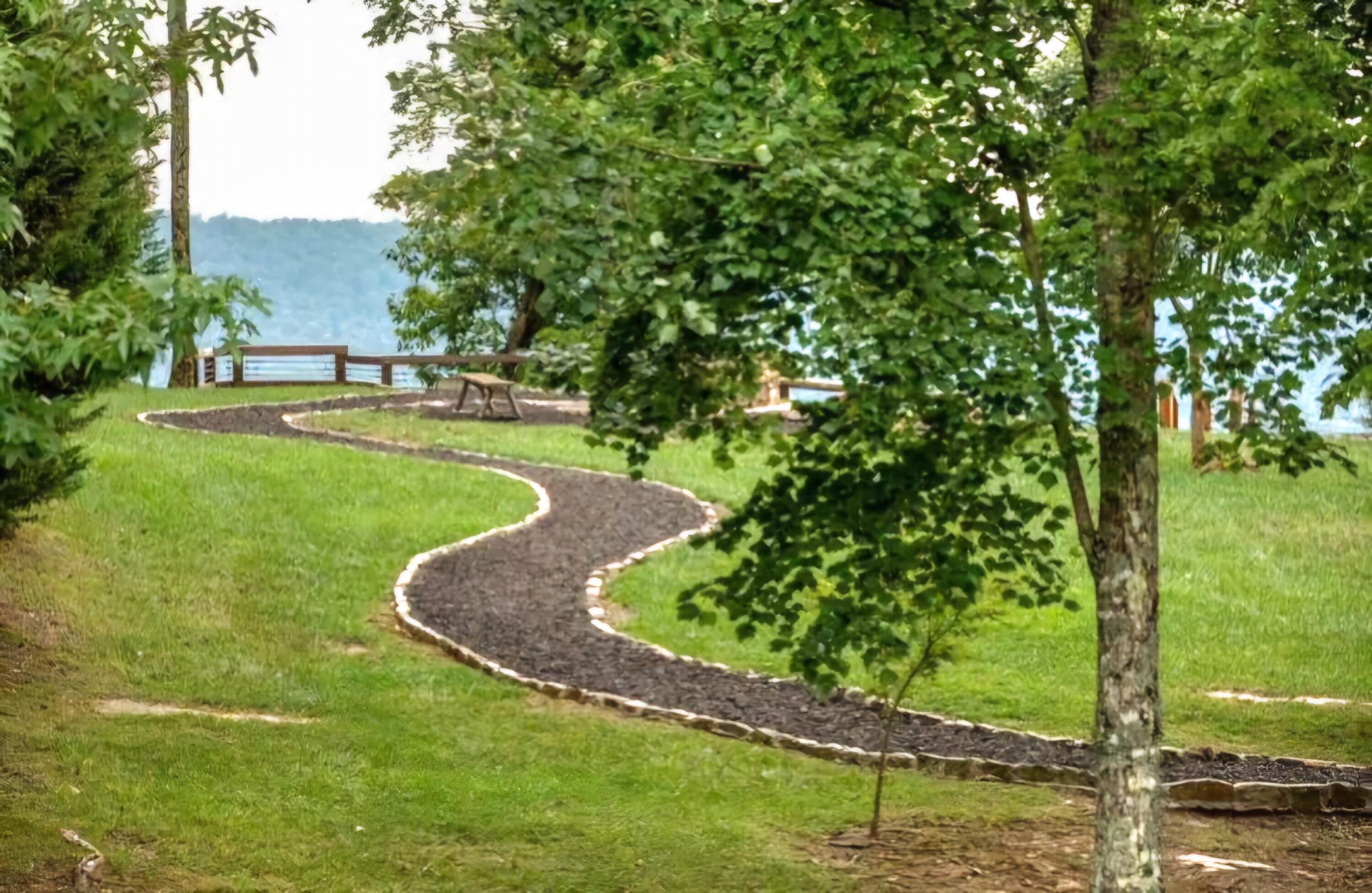 6070 Raulston Falls Drive Jasper, TN 37347 - Photo 23 of 28 a view of a garden with a bench in the middle