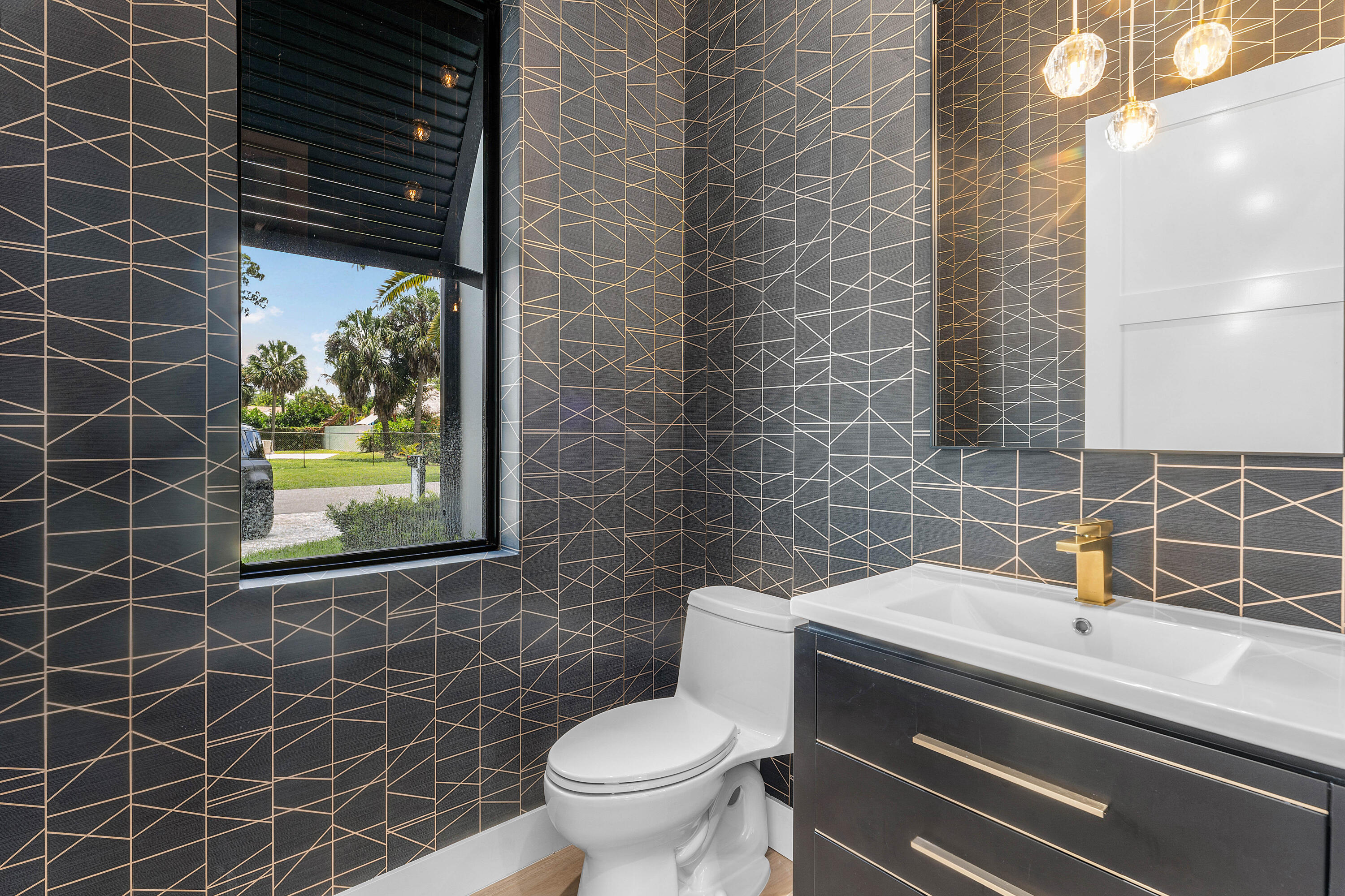 5701 Old Orange Road Jupiter, FL 33458 - Photo 13 of 46 a bathroom with a toilet a sink and mirror