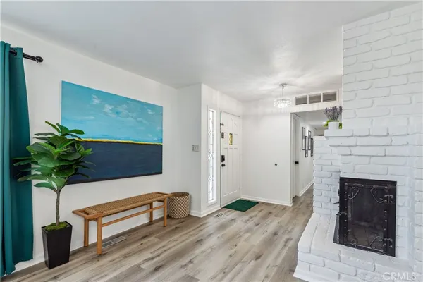 a kitchen with stainless steel appliances a sink a stove a refrigerator cabinets and a window