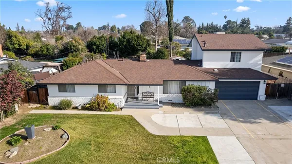 an aerial view of a house with yard swimming pool and outdoor seating