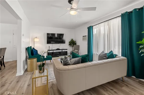 a kitchen with stainless steel appliances a white table chairs and a refrigerator