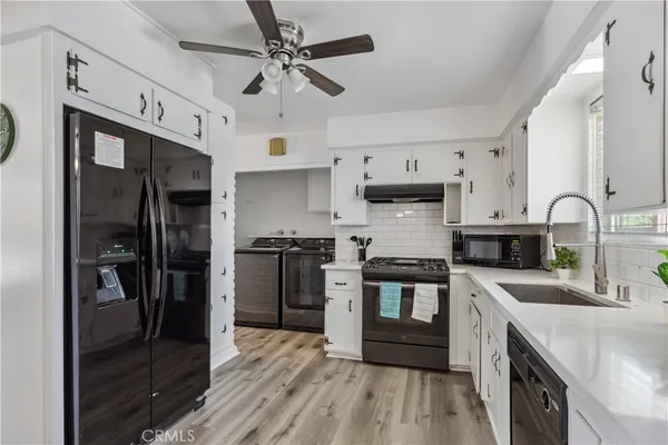 a bathroom with a granite countertop toilet sink and mirror