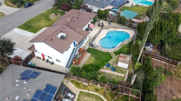 an aerial view of residential house with outdoor space and swimming pool